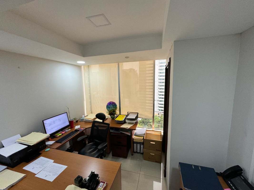 Modern office layout with large windows and file cabinets overlooking city in Obarrio Business Tower