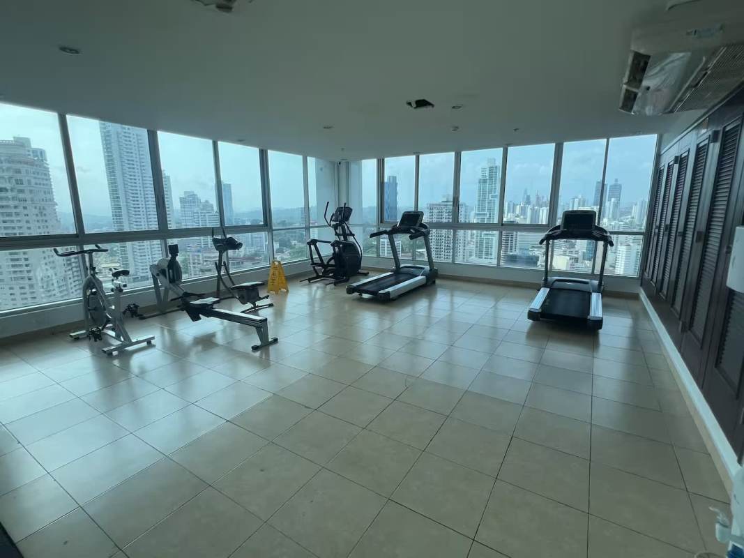 Modern gym with cardio equipment panoramic city ocean views PH Villa del Mar Avenida Balboa Panama
