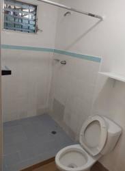 Simple bathroom with shower toilet tiled walls blue accents Vacamonte Panama