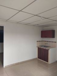 Minimal kitchen space with tiles backsplash white walls brown cabinets Vacamonte Panama