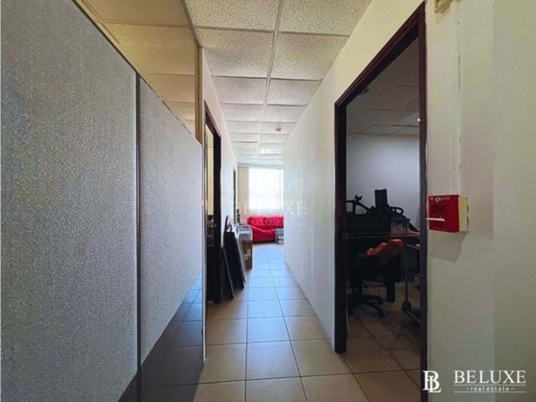 Drop ceiling tiled hallway with individual office rooms Panama