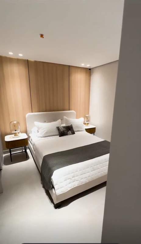 Bedroom with wood accent wall and minimalist decor Villa de las Fuentes Panama