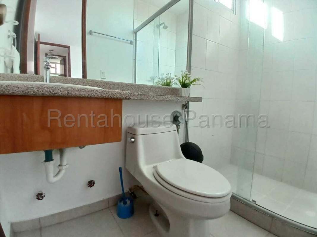 Bathroom with granite vanity and glass shower at PH Terramal San Francisco Panama City