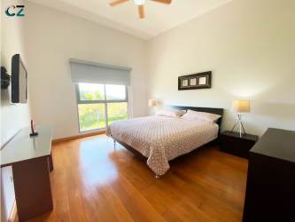 Outdoor swimming pool and sun deck for residents at PH Soleo Panama