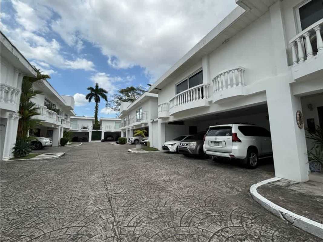 Elegant Mediterranean style white facade and garages of house in Altos del Golf residential community Panama City