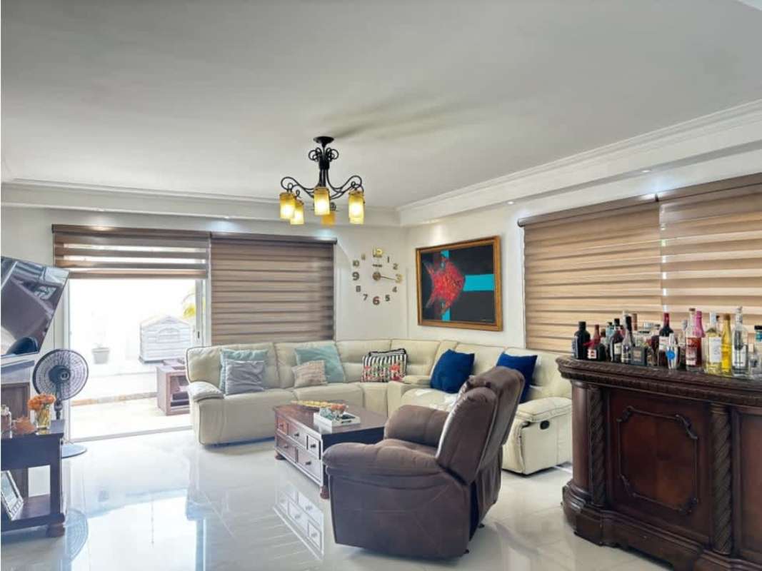 Contemporary living area with sectional sofa and bar counter in Altos del Golf family house Panama