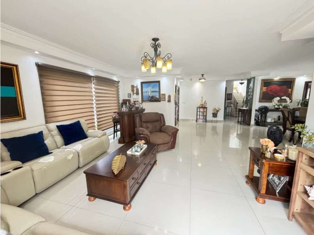Large dining area with chandelier and sliding doors to garden and pool in luxury Panama City home