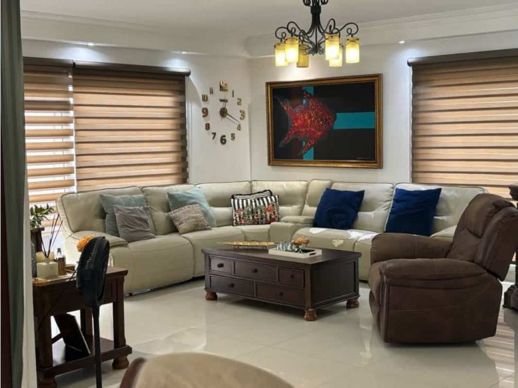 Elegant formal living room with beige sofas, recliner, chandelier in Altos del Golf Panama City