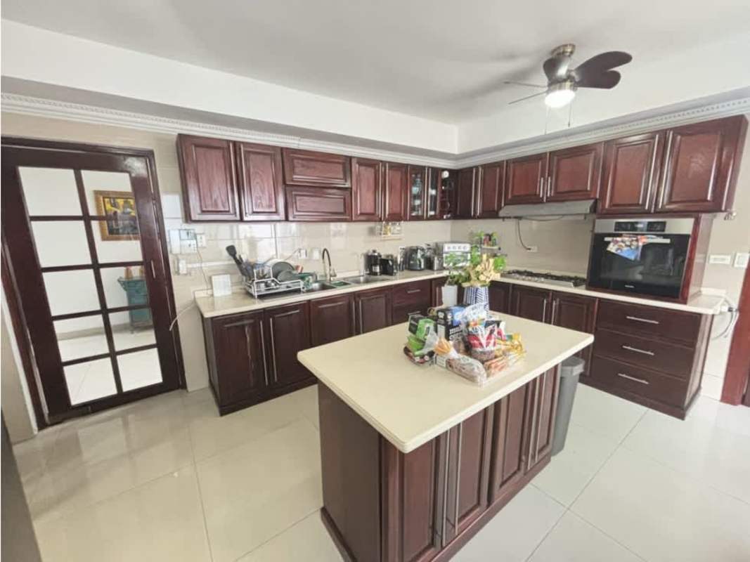 Kitchen with wood cabinets and modern appliances in exclusive house Altos del Golf San Francisco Panama