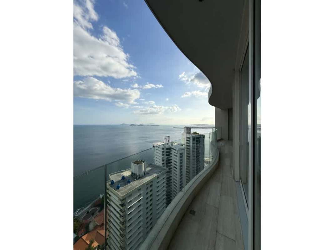 Curved high-rise balcony with panoramic ocean and city views at PH The Towers Panama