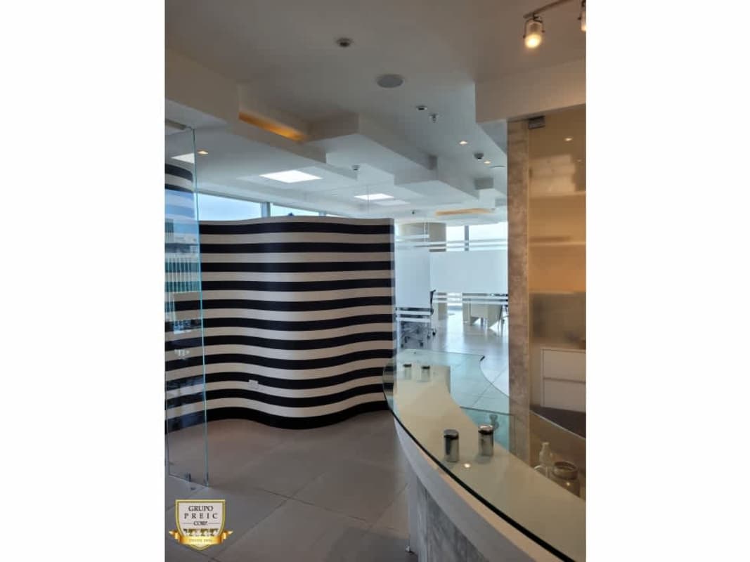 Reception with curved glass counter yellow accent wall in Oceania Business Plaza Punta Pacifica Panama