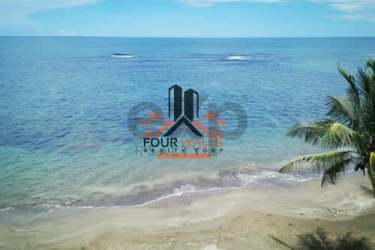 Clear blue ocean with sandy beach perfect for eco vacation at Arcadia Beach Costa Abajo Panama