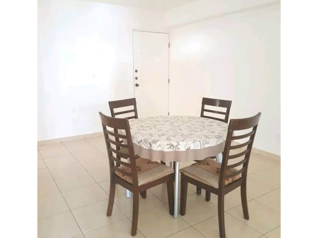 Bright dining area with round table floral cloth four chairs tiled floor PH Pacific Blue Panama City