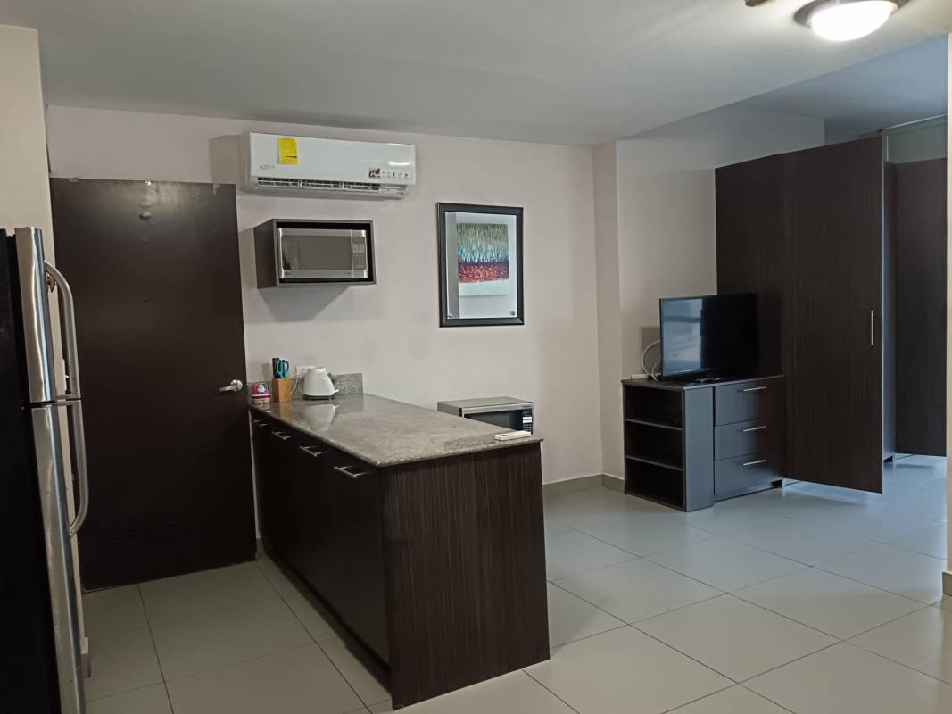 Open plan living sleeping area with large windows, city view, modern furnishings at PH Colores de Bella Vista