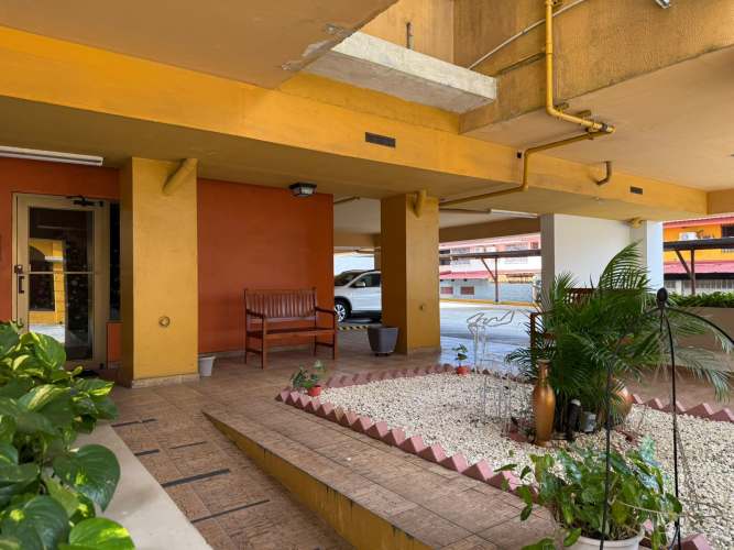 Covered entry with garden planters and parking at PH Parque Lefevre Panama City