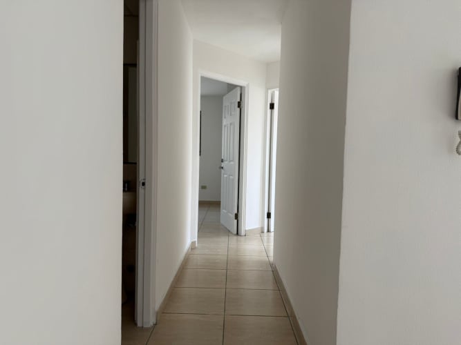 Bright hallway inside apartment with tiled floors in PH Parque Lefevre Panama