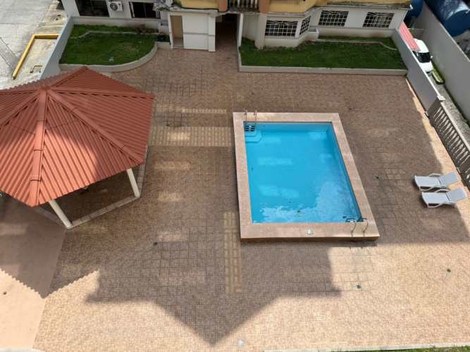 Aerial of swimming pool, gazebo, landscaped areas in gated complex Parque Lefevre Panama