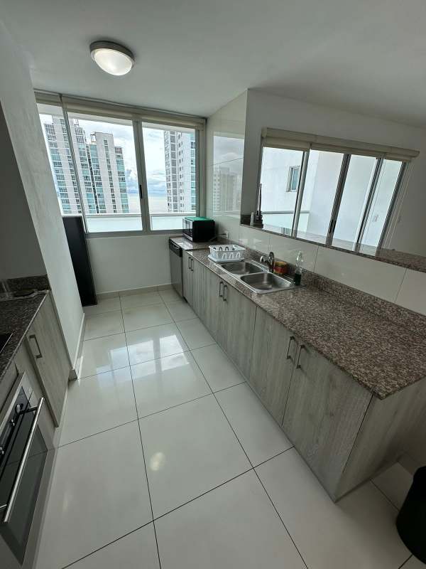 Kitchen with granite countertops, large windows, modern cabinetry and city view at PH Moon Tower Panama