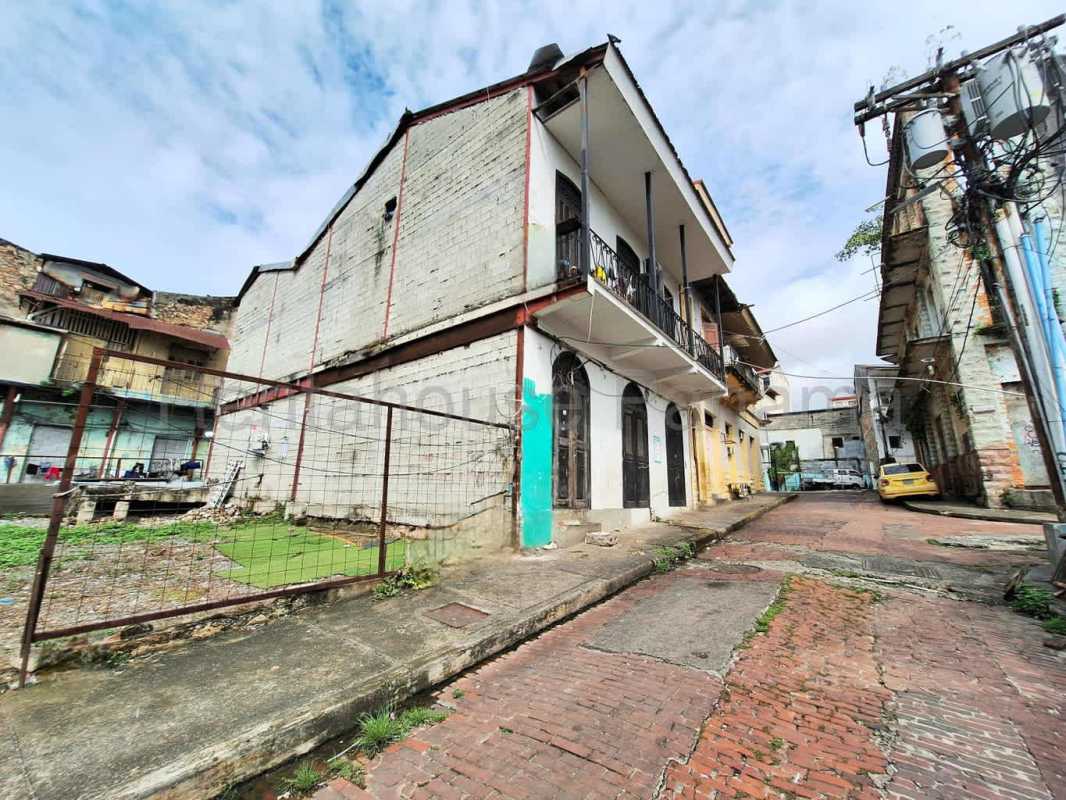 Colorful colonial facades line the street next to vacant lot in Casco Viejo