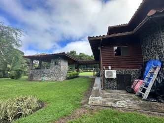 Rustic stone wall wooden facade tiled roof cabin estate El Valle