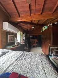 Country bedroom wooden walls beams large window mountain garden El Valle Anton