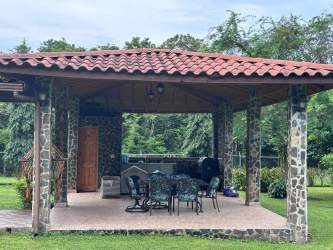 Rustic bedroom wood walls ceiling fan mountain garden view El Valle Anton