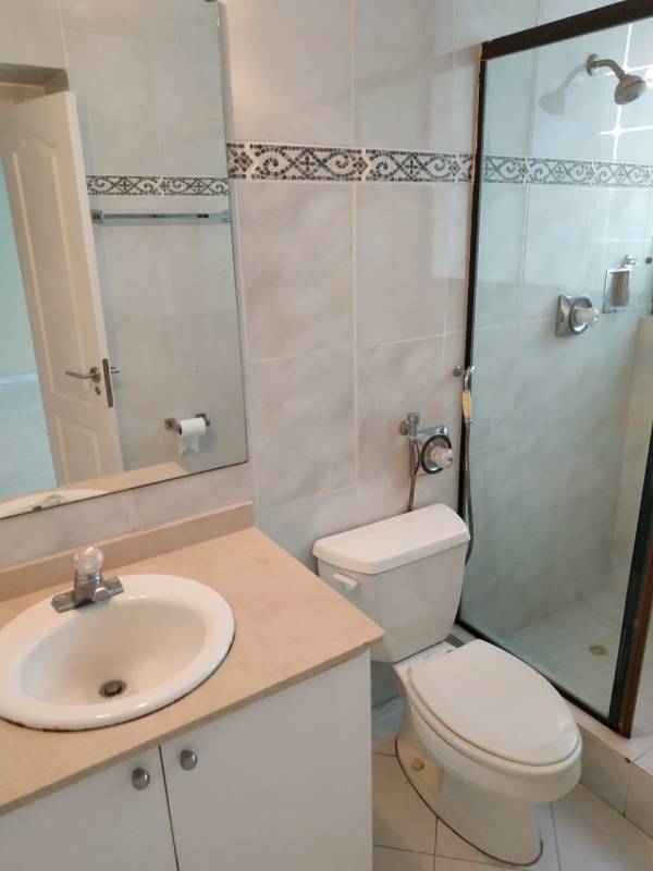 Luxury bathroom with marble finishes, double sinks and glass enclosed shower in PH Miramar Avenida Balboa