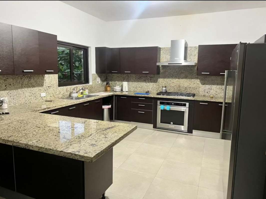 Spacious modern kitchen with granite counters and stainless appliances in Embassy Club house Panama