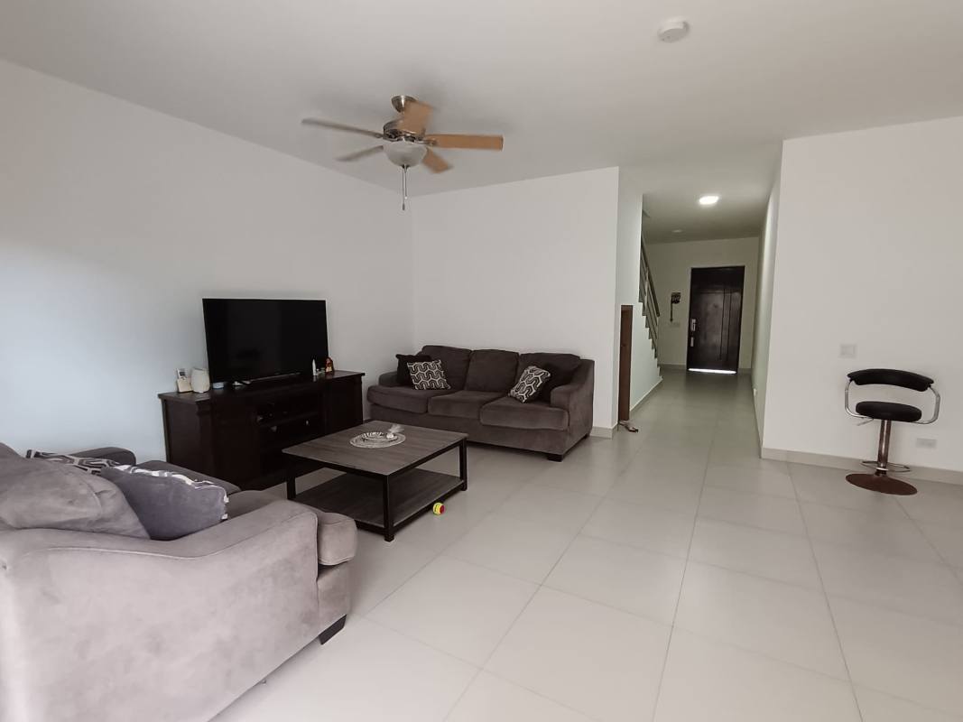 Kitchen with granite countertop, dark wood cabinets and gas stove at Altos del Parque Pedregal Panama