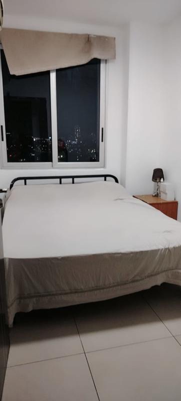 Bedroom with large window showing Panama City night view PH Macedonia El Ingenio