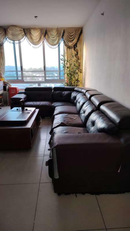 Bright living area with large windows and black sectional sofa in PH Macedonia El Ingenio Panama City