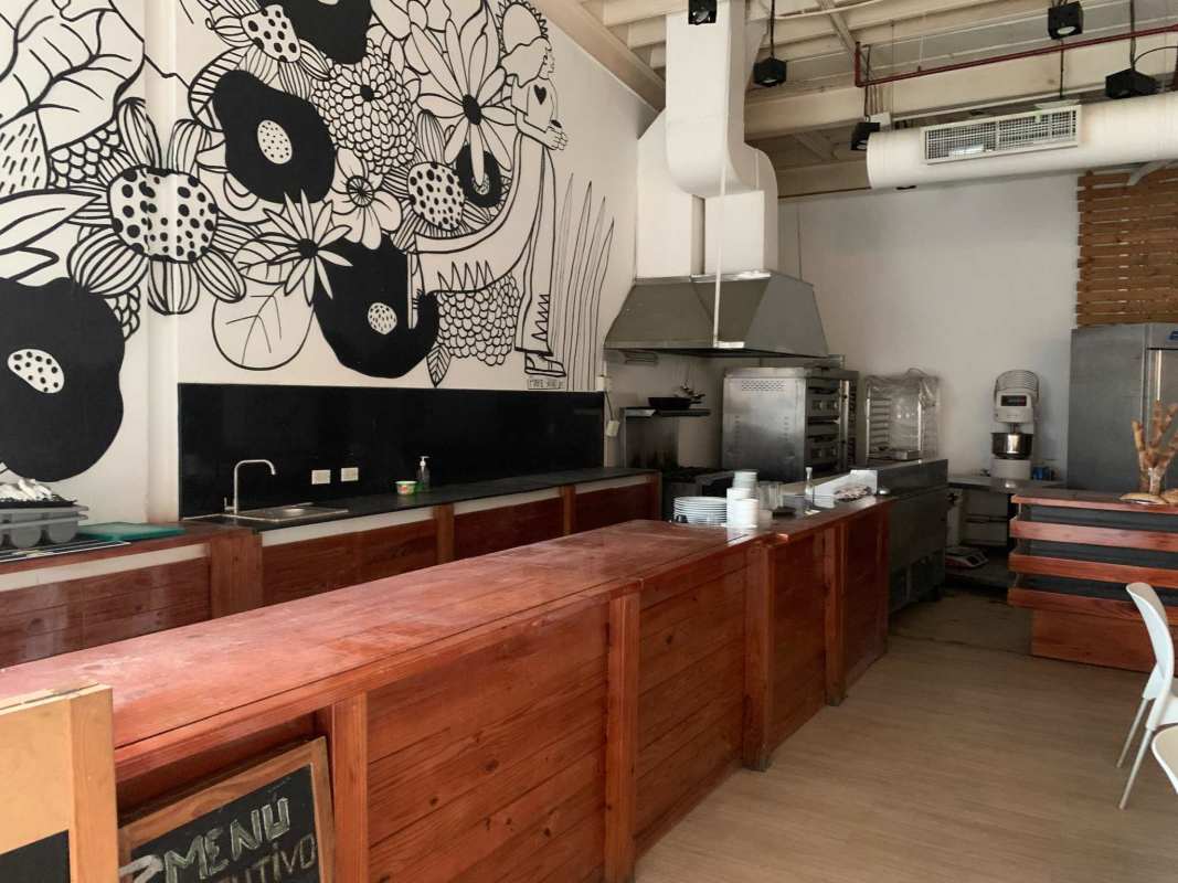 Cafe seating with large glass window showcasing Panama City skyline on Avenida Balboa
