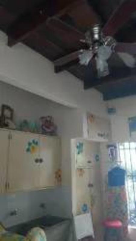 Traditional kitchen with ceiling fans, wood beams and wall cabinets Los Angeles Betania house