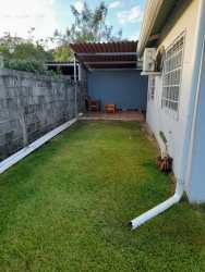 Green lawn backyard covered seating area private yard single family home Quinta del Pacifico Panama
