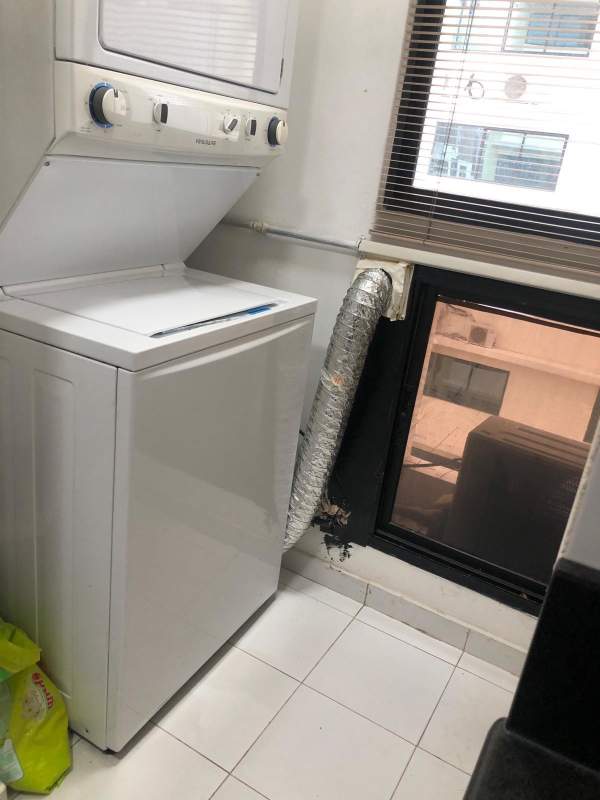 Laundry space with washer and utility sink in apartment Palm Beach Tower Marbella Panama for rent