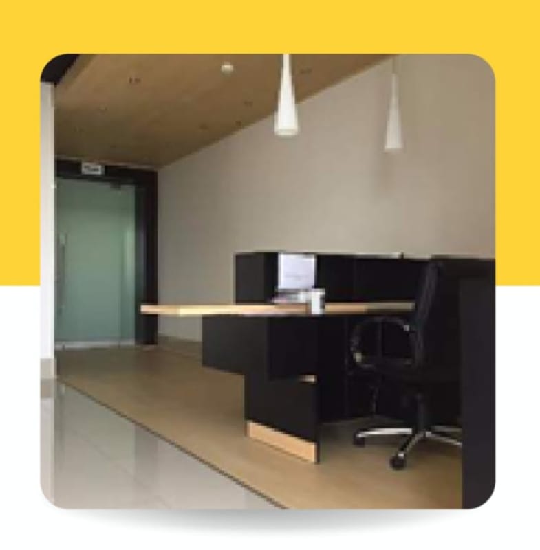 Modern reception with textured accent wall, seating and pendant lighting at BICSA Financial Tower Panama