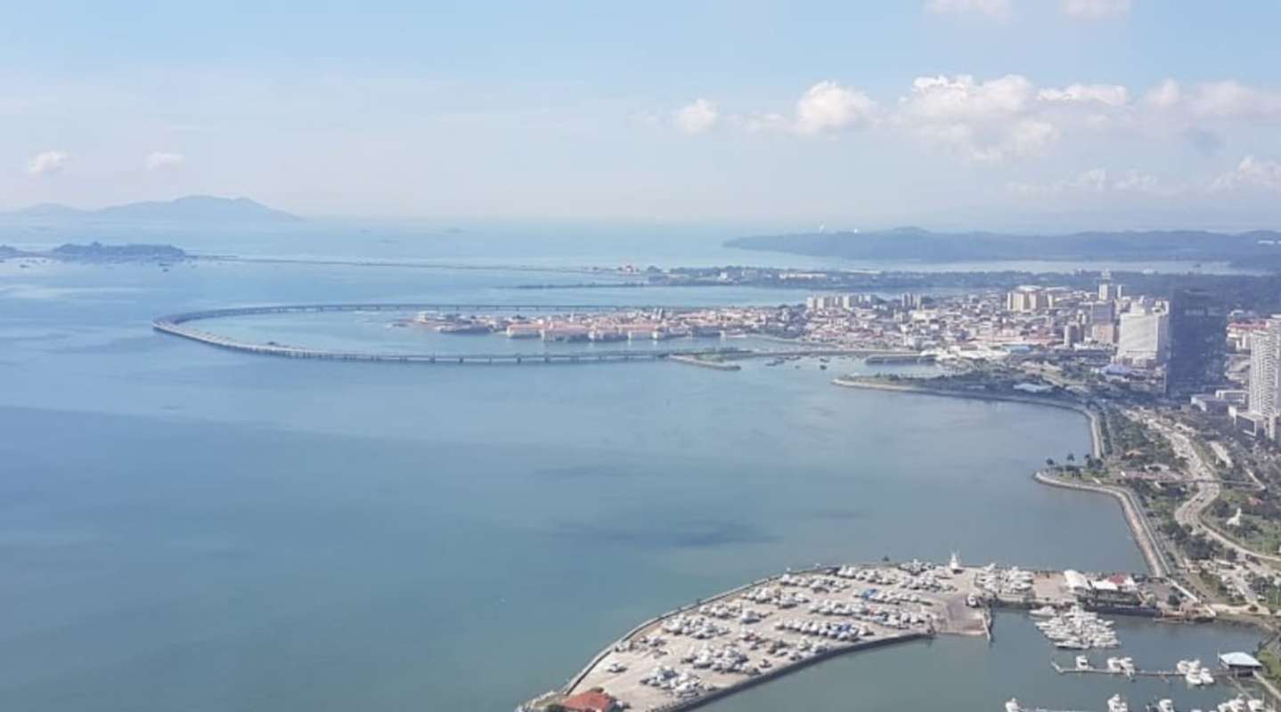Panoramic aerial cityscape with marina, ocean bay, and BICSA Tower location Panama City