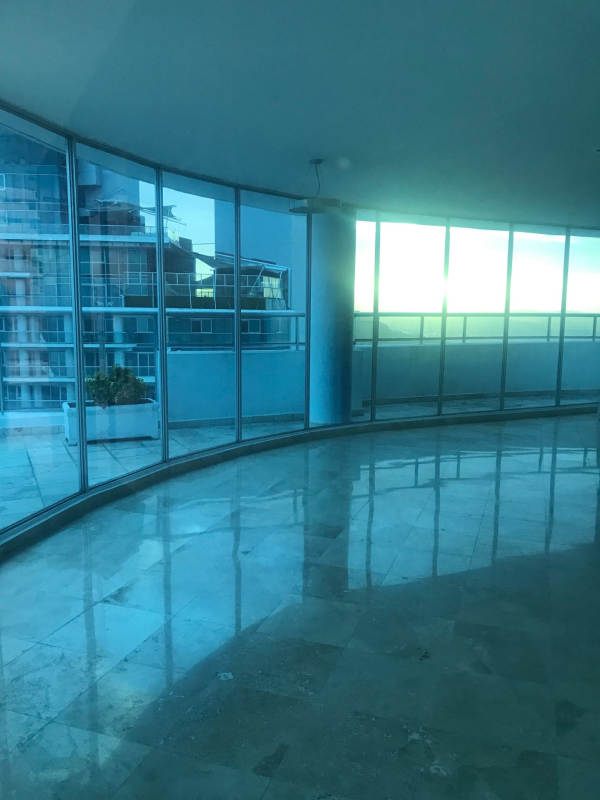 Spacious living room floor-to-ceiling windows with ocean and city views Sky Tower Panama