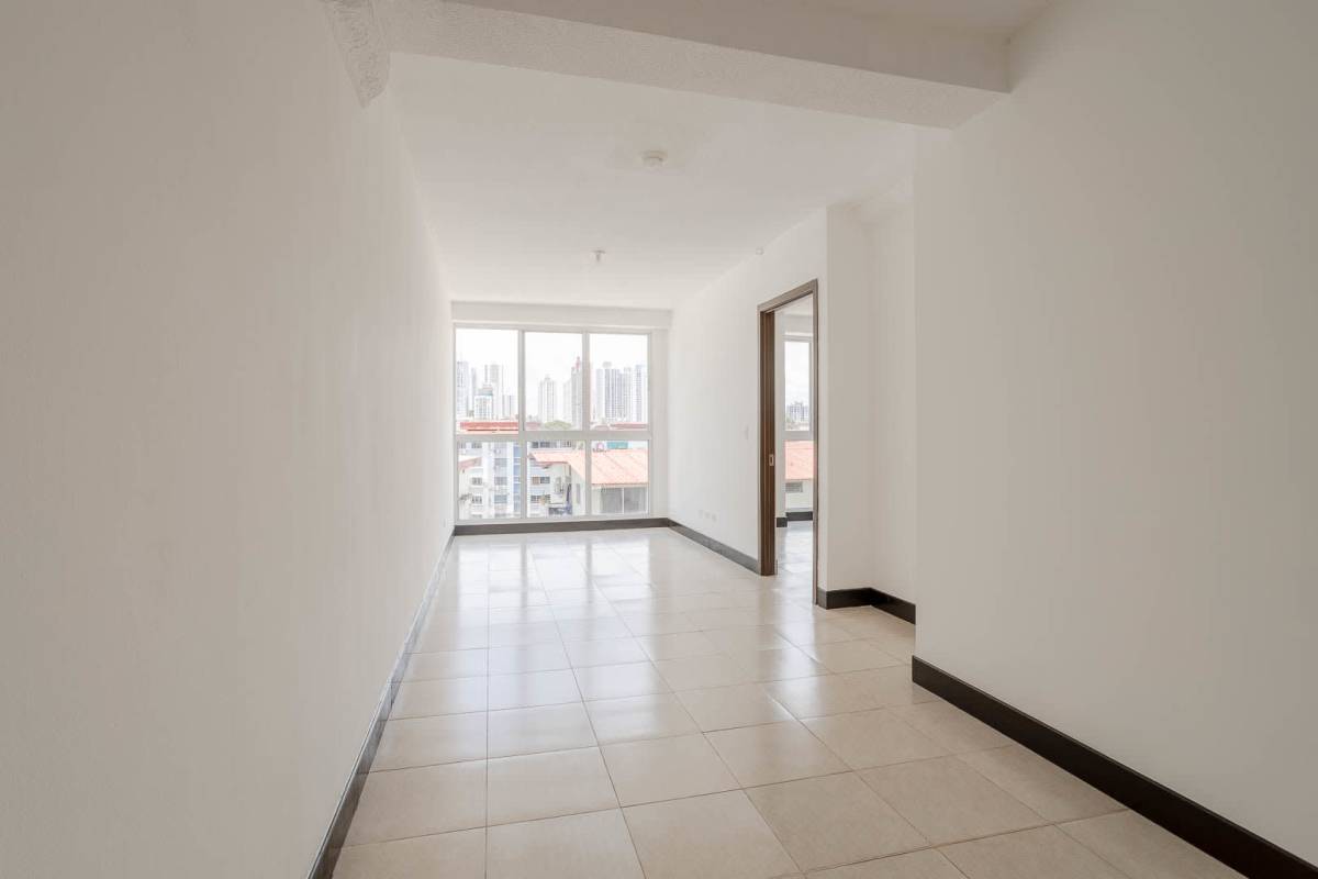Open kitchen with granite countertops and wood cabinetry in apartment PH Sorrento Parque Lefevre Panama City