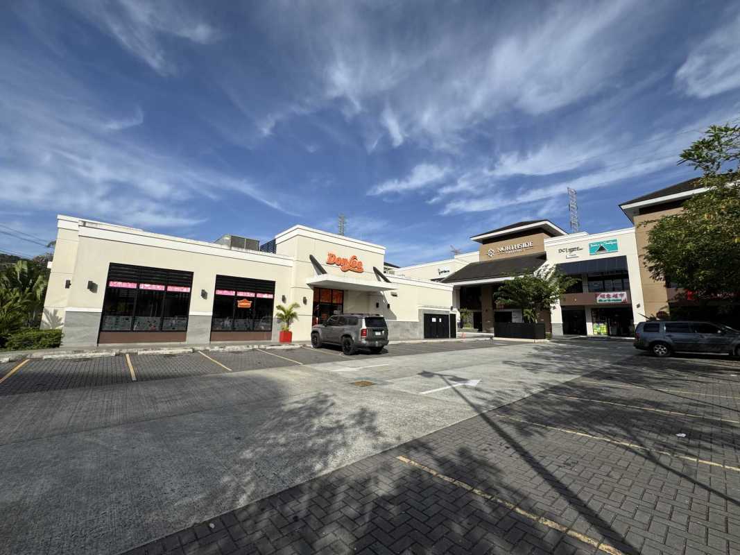 Modern commercial center facade with signage balconies retail stores Brisas del Golf Panama