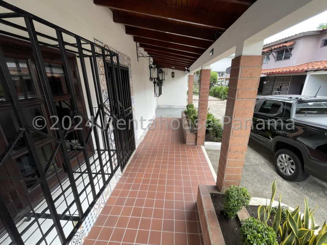Spacious bedroom with wood wardrobes, AC and ceiling fan in San Francisco Panama home
