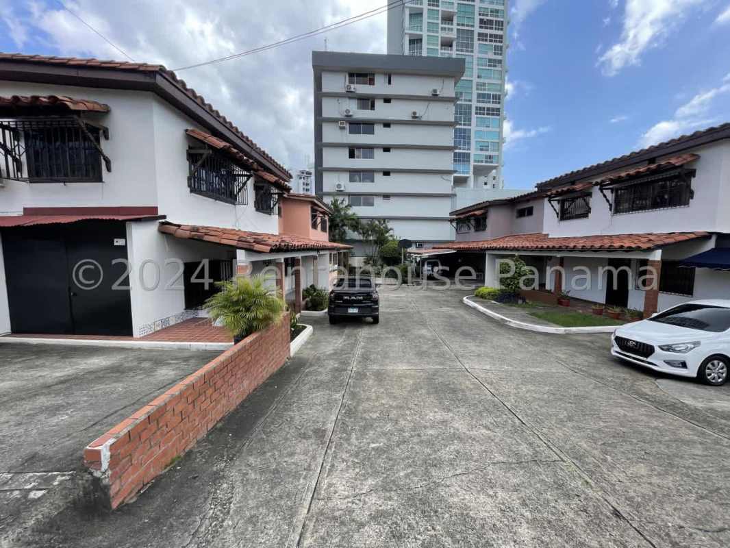 Elegant dining room with exposed wood beams, vintage decor, chandelier in Panama City house