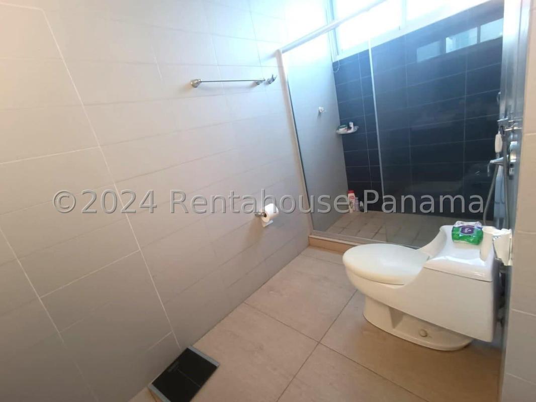 Modern living room with balcony access overlooking Panama Bay at PH Bellavista Tower