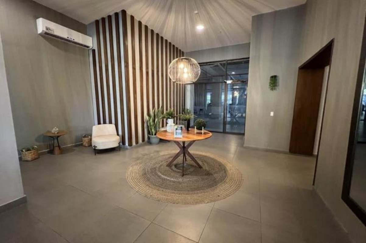 Spacious bedroom with tiled floor, large wardrobe, accent wall PH Condado Gardens Panama