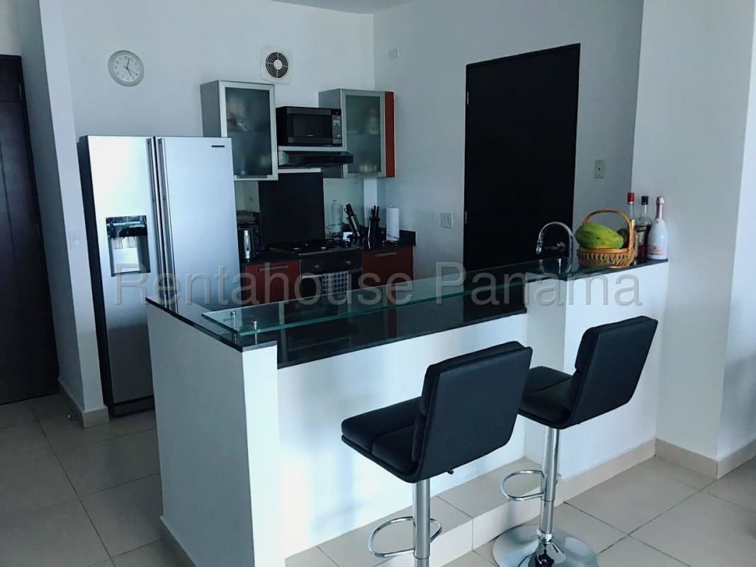 Contemporary kitchen with granite counter, breakfast bar and stainless appliances at PH BICSA Panama City