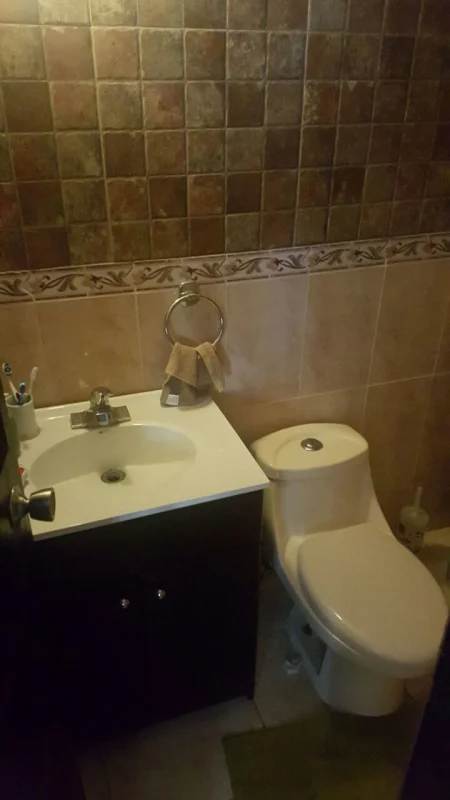 Spacious living room with tile floor, ceiling fan and large window in Cerro Viento home for rent