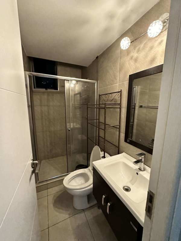 Contemporary bathroom with glass-enclosed shower and tiles PH Via España Panama