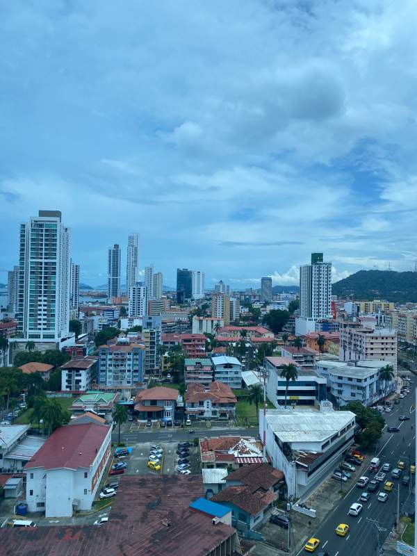 City skyline aerial view including Signature Point high-rise and mountains in background, Panama City
