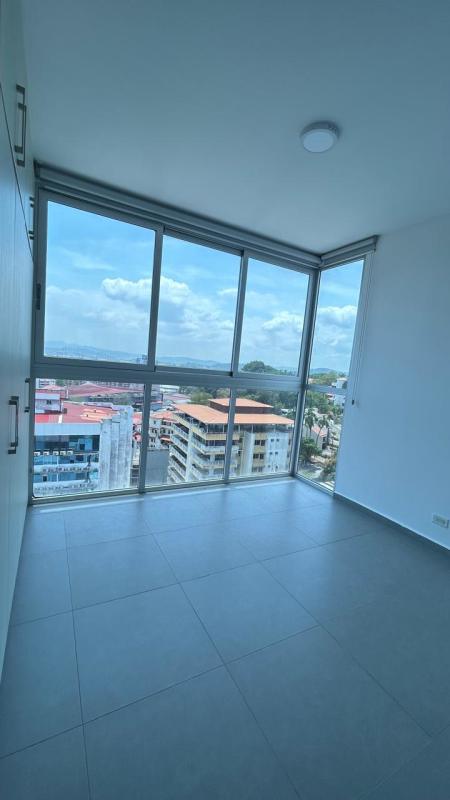 Modern bedroom with large floor-to-ceiling windows offering city views at PH Signature Point Panama City