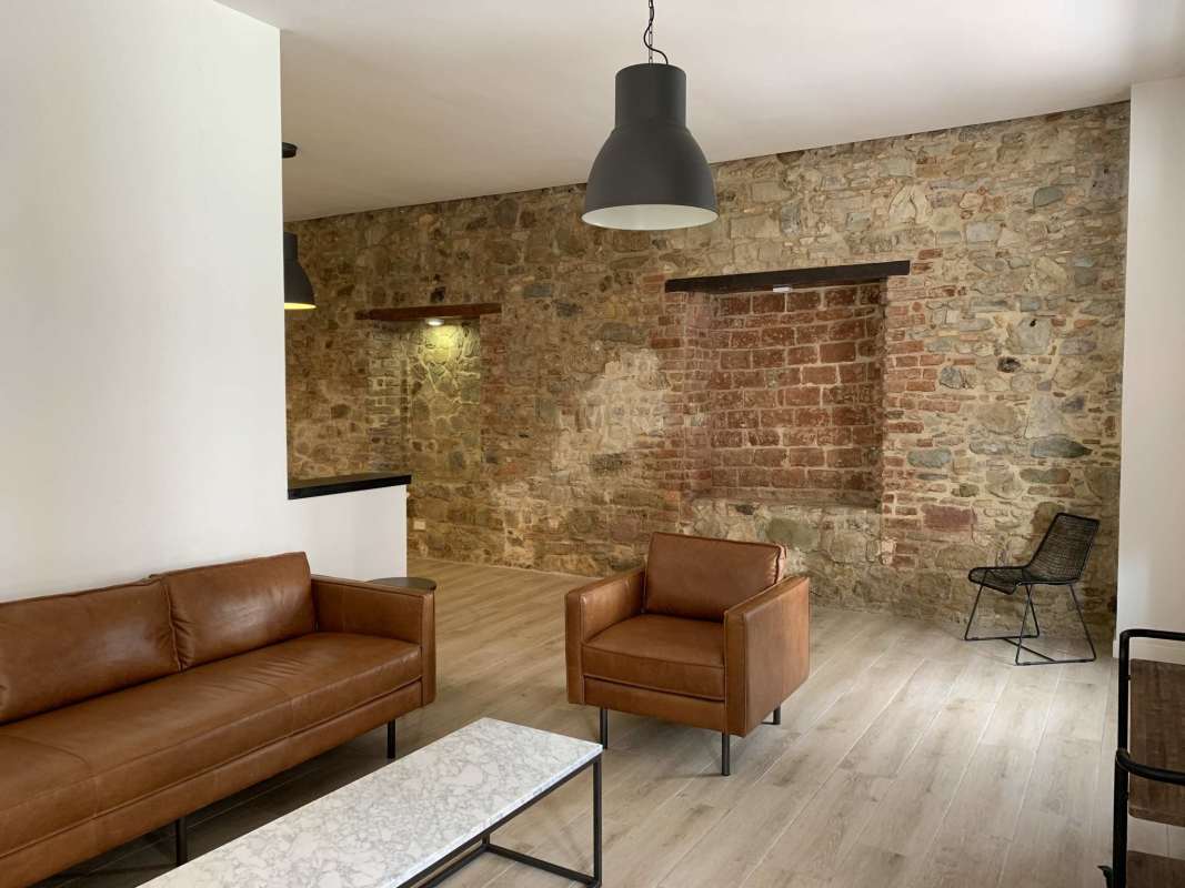 Gourmet kitchen with island, exposed stone feature wall and modern fixtures Casco Viejo condo Panama